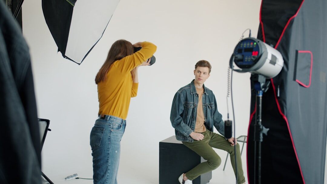 Photographer adjusting studio lighting before a portrait session