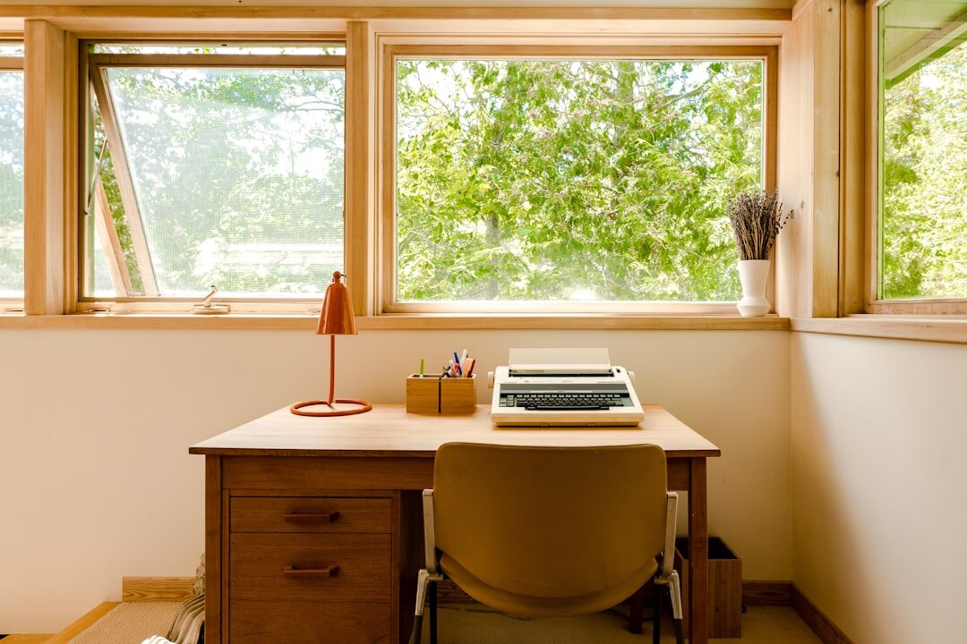 Quiet editorial studio desk with typewriter and notebooks